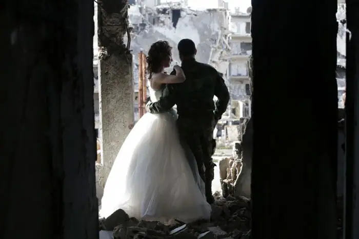 Syrian newlyweds survey the damage to the city
